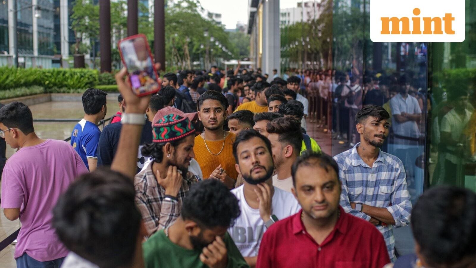Customers queue outside an Apple Inc. store ahead of its opening hours during the first day of sale of the iPhone 17 smartphone in Mumbai.