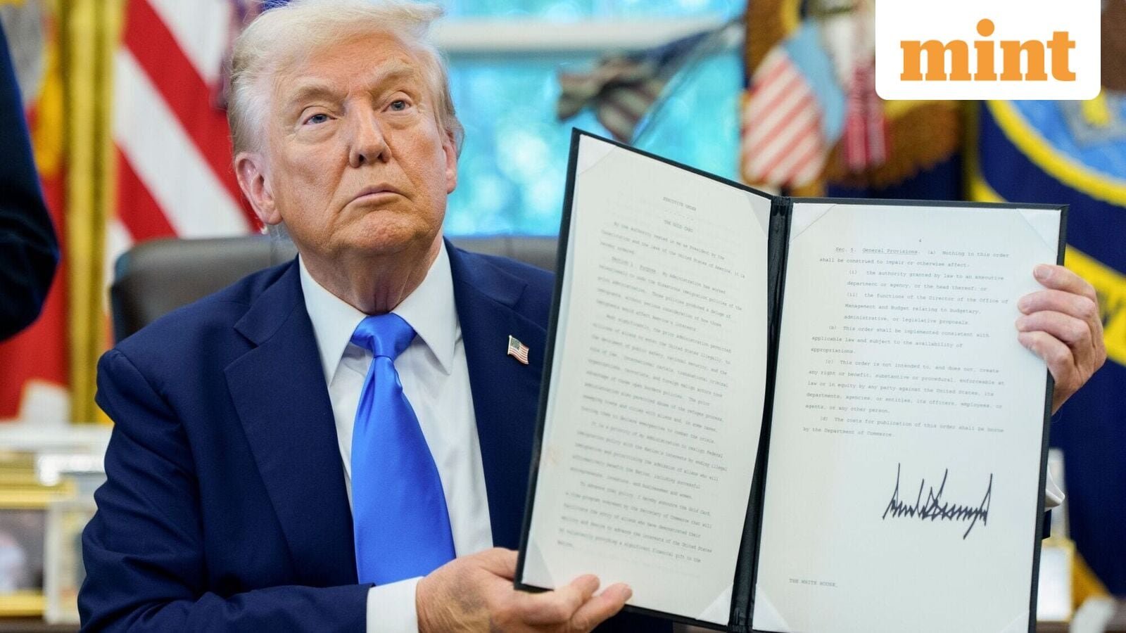 US President Donald Trump holds a signed executive order to increase H-1B visa fee to $100,000 fee.