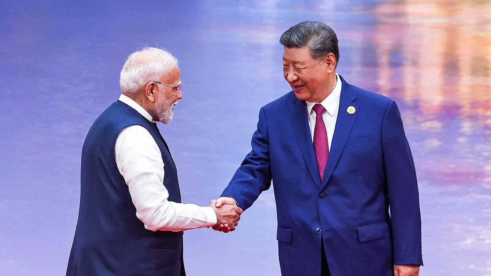 Prime Minister Narendra Modi (L) and China's President Xi Jinping shake hands during the welcoming ceremony of the Shanghai Cooperation Organization (SCO) summit in Tianjin.