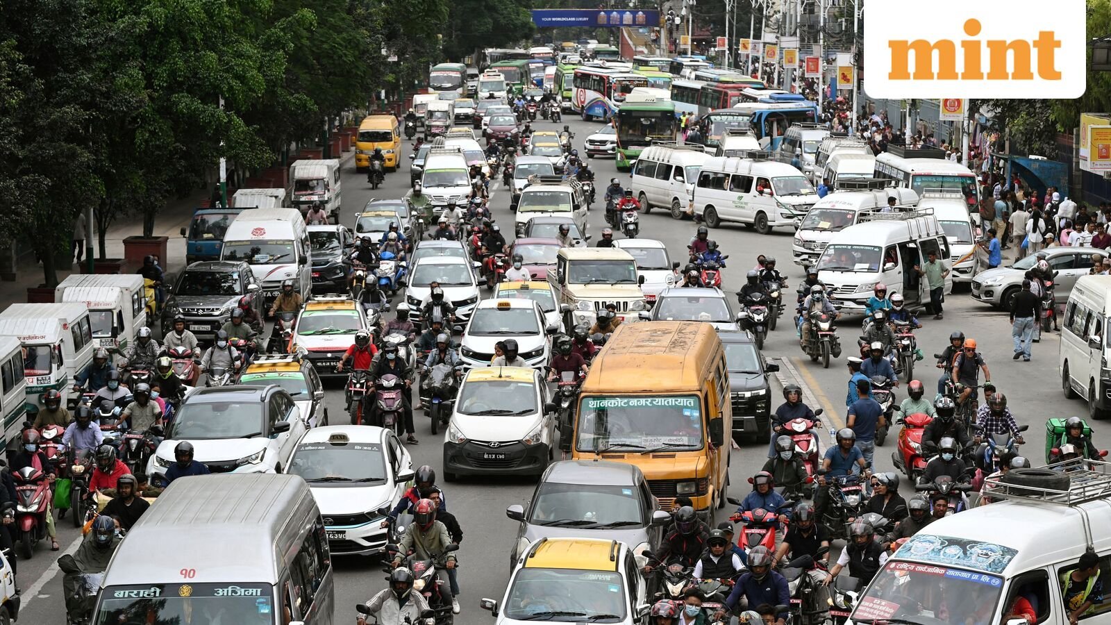 People commute along a busy road in Kathmandu, Nepal, on September 19.