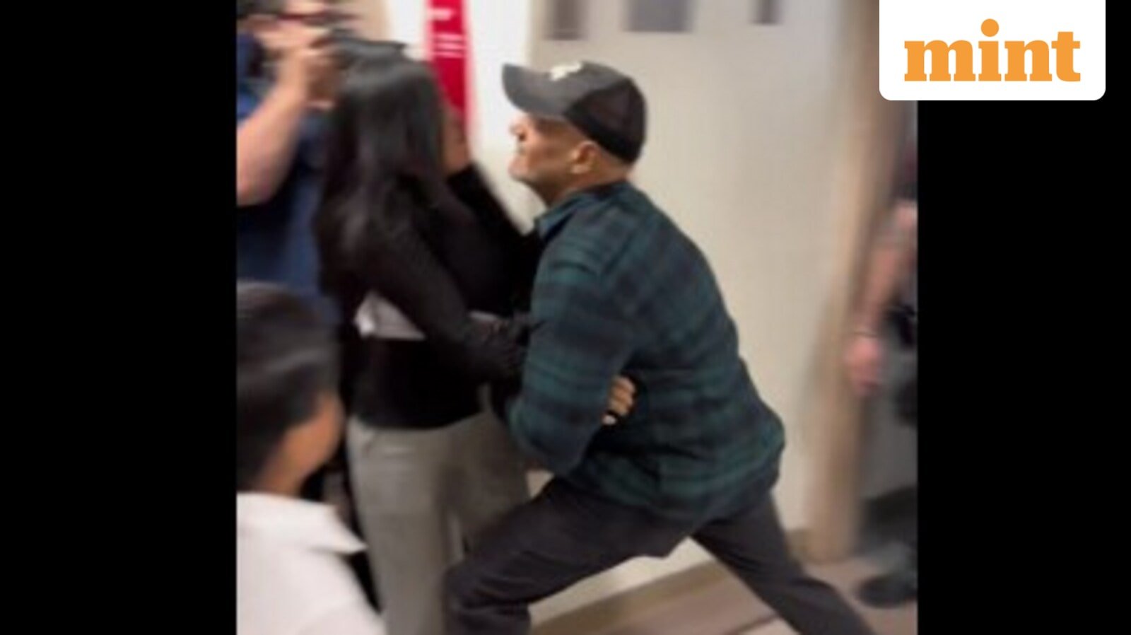 A federal immigration officer in Manhattan has been relieved of duties after pushing an Ecuadorian woman to the floor during her husband's arrest. (Screengrab from the viral video)