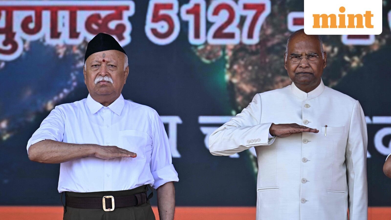 Rashtriya Swayamsevak Sangh (RSS) chief Mohan Bhagwat (L) and India's former President Ram Nath Kovind attend the centenary celebrations of the Hindu nationalist organisation at Reshimbagh Ground in Nagpur on October 2, 2025. (Photo by Idrees MOHAMMED / AFP)