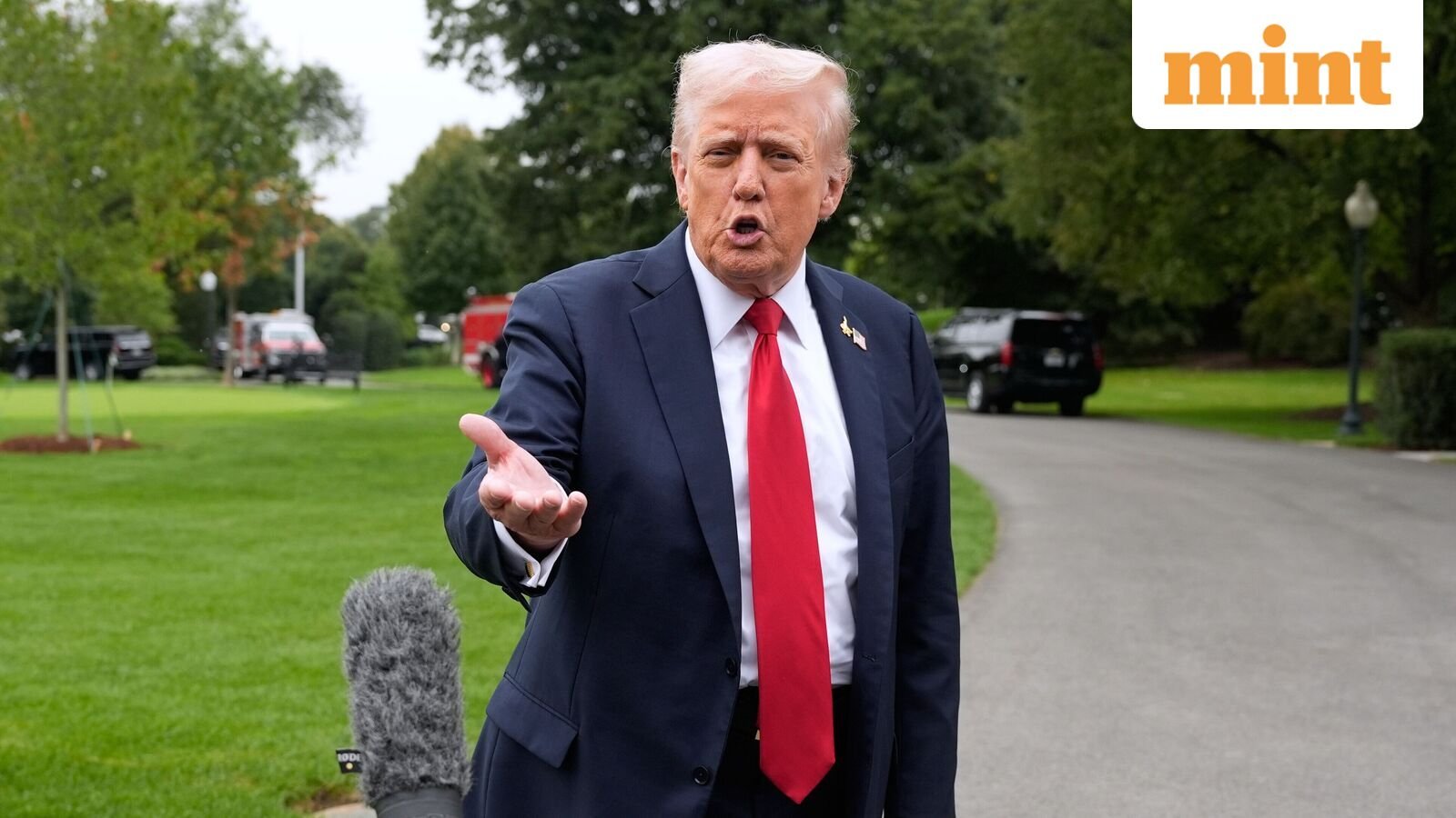US President Donald Trump speaks with reporters as he walks from Marine One after arriving on the South Lawn of the White House, Tuesday, Sept. 30, 2025, in Washington.