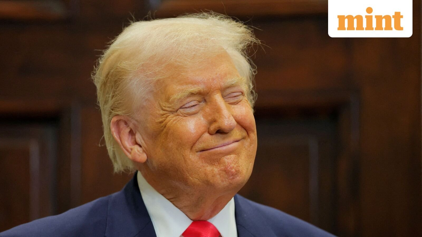 US President Donald Trump smiles during an announcement